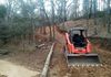 Excavating and grading for a new gravel driveway on a hillside in Pilot Point, Texas.