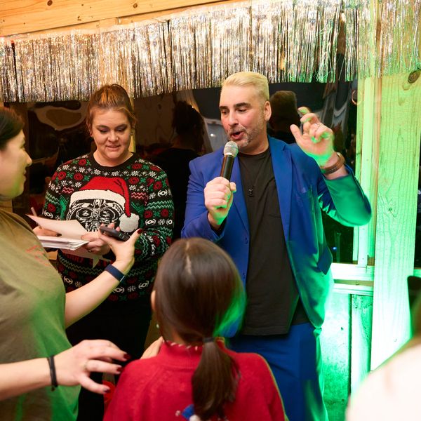 Group enjoying karaoke at a festive party.