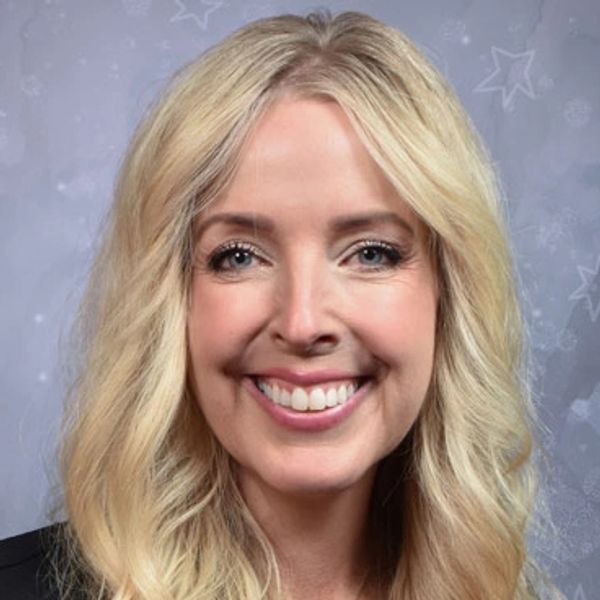 Smiling woman with long blonde hair.