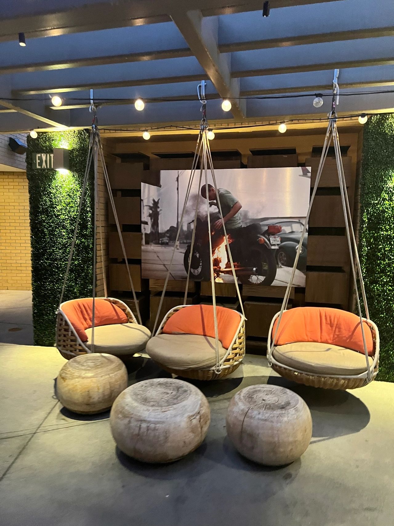 The swing chairs in the corner of the rooftop