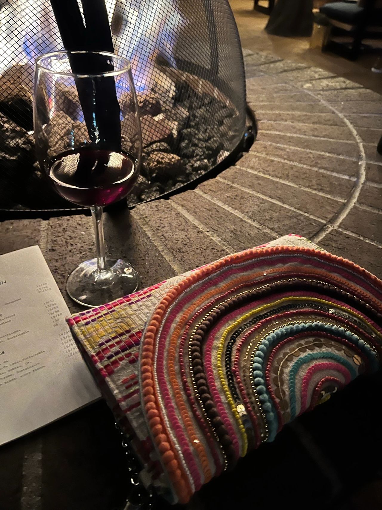 A glass of red wine by the fire
