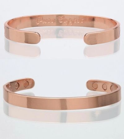 Rose gold open cuff bracelet with magnetic elements.
