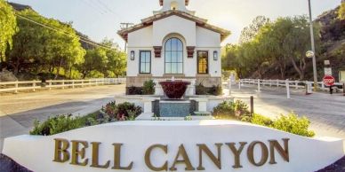 Entrance to Bell Canyon with a decorative fountain and white building.