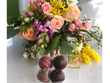 Bouquet of flowers with chocolates.