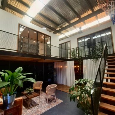 Modern loft with plants and cozy seating.