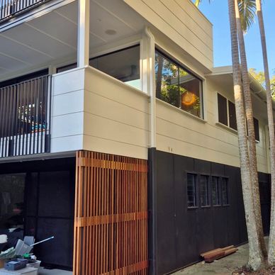 Modern two-story house with wood and black exterior.