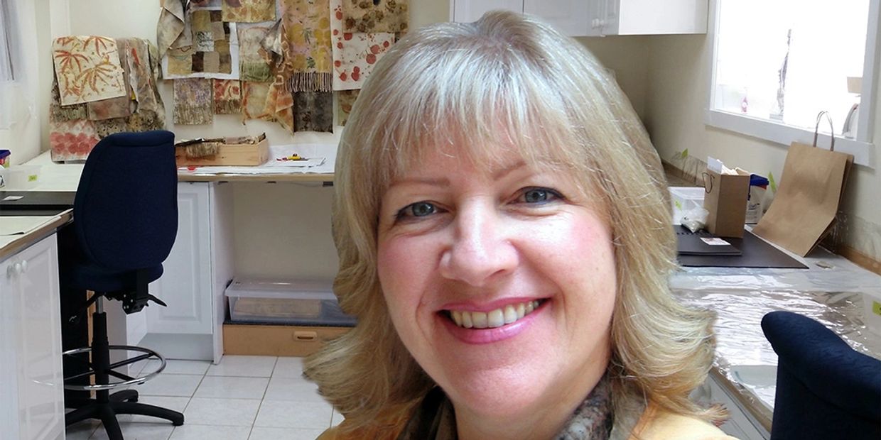 Photograph of textile artist, Tina Whiteley, in her studio