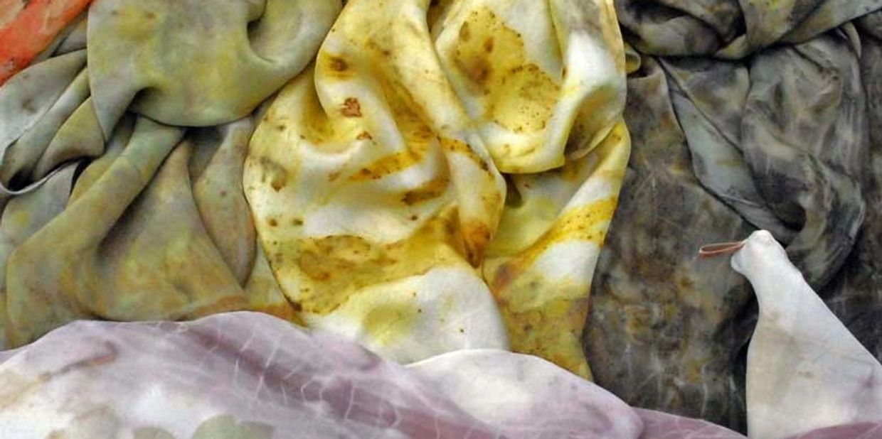 Photograph of colourful eco-dyed silk scarves