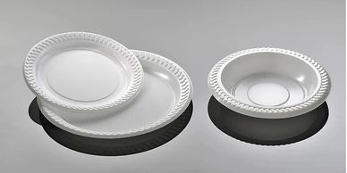 White foodservice plates and bowls on a neutral background