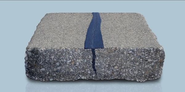 Hot rubberized sealant used to fix crack in drive.