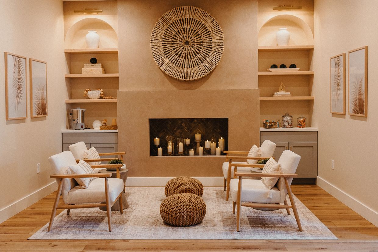 Luxury spa relaxation lounge in Moorpark, CA at Illuminé Skin & Wellness. Fireplace with candles.