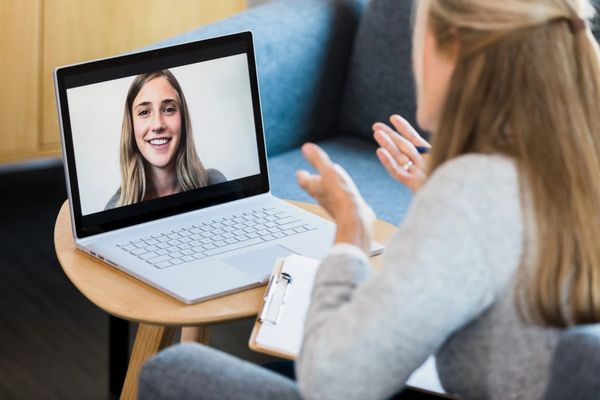 A woman talked with other women in the laptop
