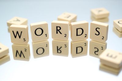 Image of scrabble pieces standing upright spelling out "words". Courtesy of Skitterphoto@pexels.com