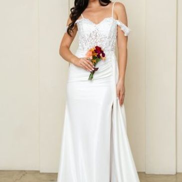 Elegant white bridal gown with lace bodice and floral bouquet.
