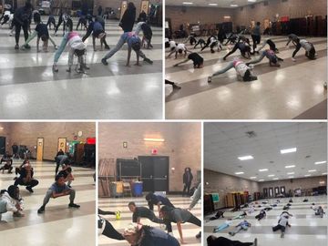 Group fitness class stretching and exercising indoors.