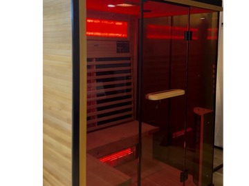 Modern home sauna with wooden interior and red lighting.
