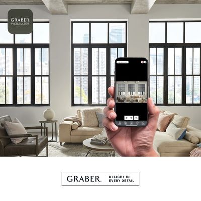 Hand holding phone showing window treatment app in modern living room.