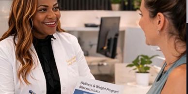 A healthcare professional discusses wellness and weight program with a patient.
