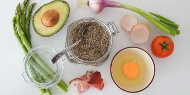 Healthy ingredients including avocado, asparagus, egg, tomato, and chia seeds.