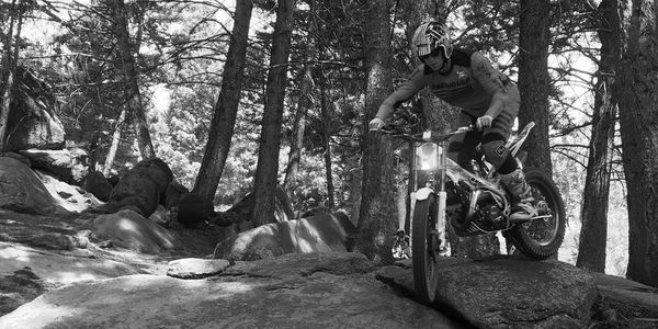 Intermediate trials rider navigates some off-camber terrain. 