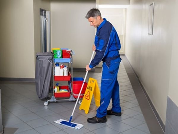 Person cleaning a building floor