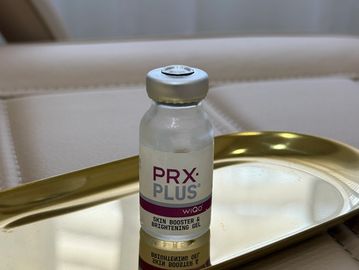 A vial of PRX Plus sits on a sterile tray in clinic ready to be used for skin treatment 