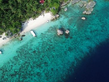 Top Down Drone Image. Dinagat Islands Boat on pristine white sand and clear turquoise water