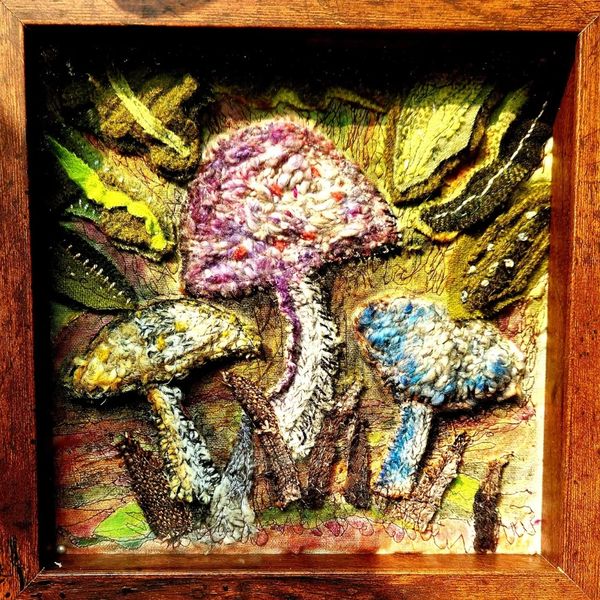 Hand stitched wool sweater mushrooms with hand painted details.