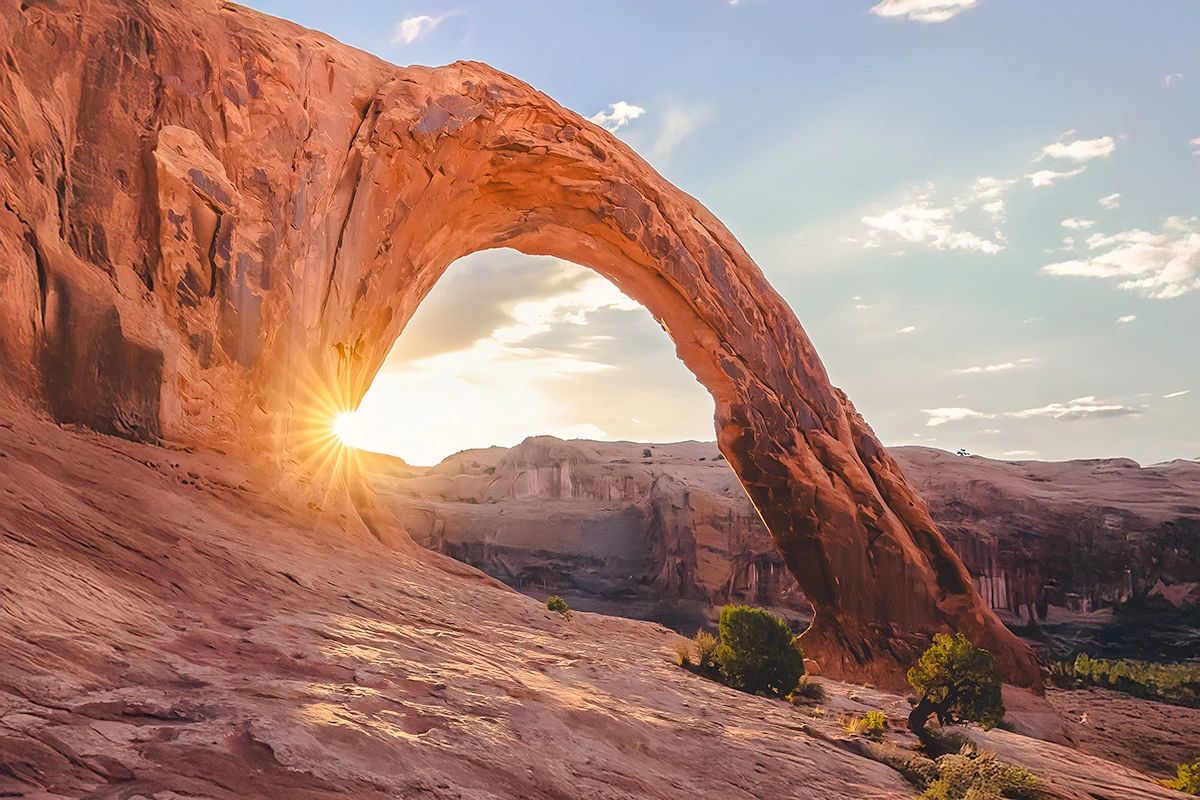 Sunrise behind Corona Arch outside of Moab, Utah Sunrise behind Corona Arch outside of Moab, Utah