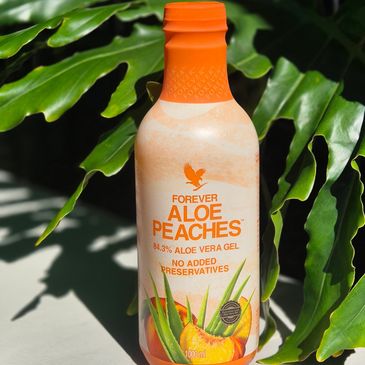 A bottle of Forever Aloe Peaches gel with aloe vera and peach flavor.