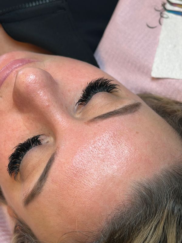 Close-up of a person's face with newly done thick eyelash extensions.