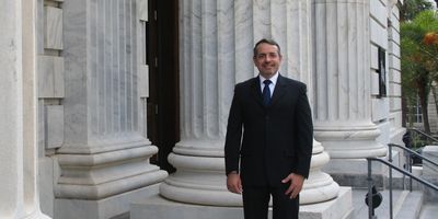 Christophe Fiori, Florida attorney and mediator, standing outside a courthouse.