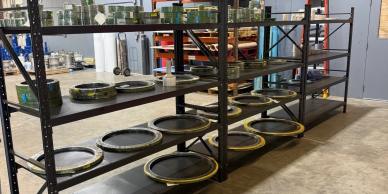 Metal plates on shelves in an industrial setting.