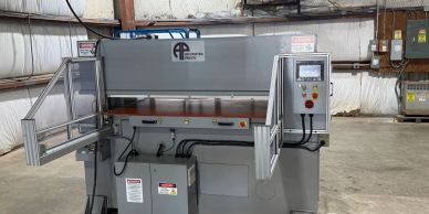 Industrial press machine in a warehouse.