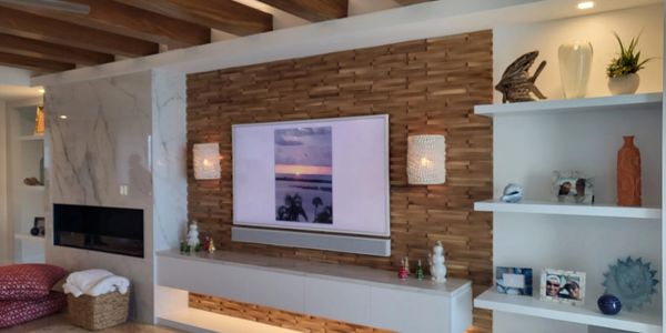 Modern living room with wooden accent wall and built-in shelves.
