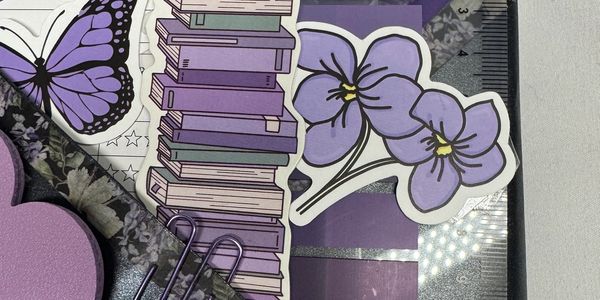 Purple-themed stationery with books, flowers, butterfly, and clips.