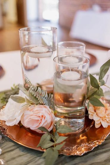 Centerpiece; floating candles, faux florals, rose gold charger plate, cheese cloth table runner