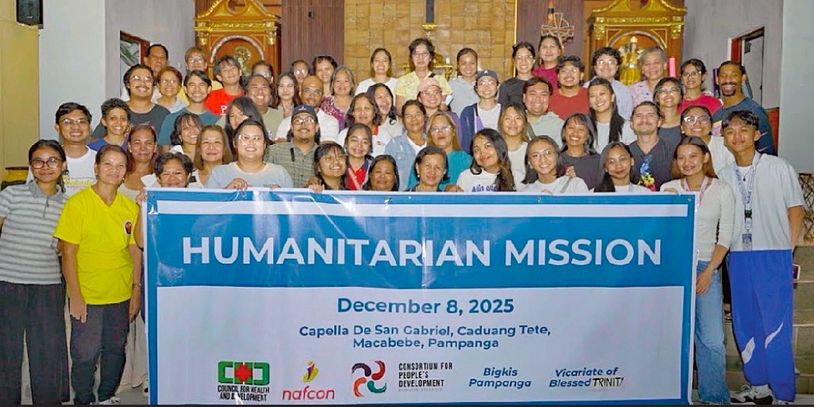 Group photo of volunteers holding a humanitarian mission banner, December 8, 2025.