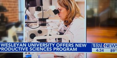 Scientist working with microscope in new Wesleyan University sciences program.