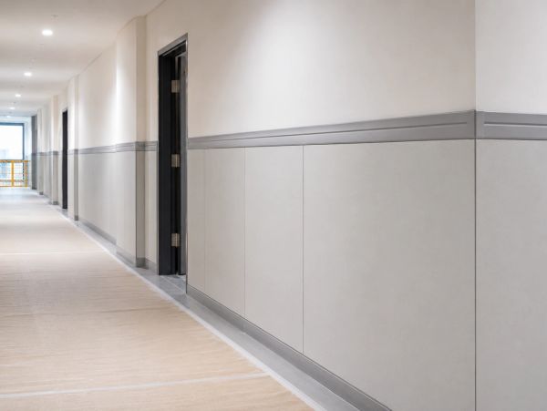 Empty corridor with open doors and plain walls.