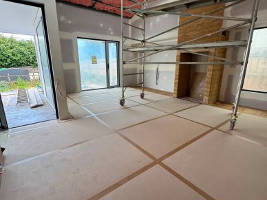 Room under construction with scaffolding inside.