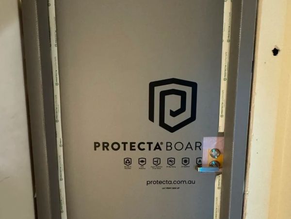 Door covered with Protecta Board for protection during construction.