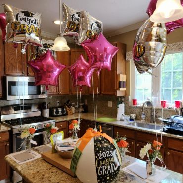 Graduation balloons and decorations in a kitchen celebrating the class of 2023.