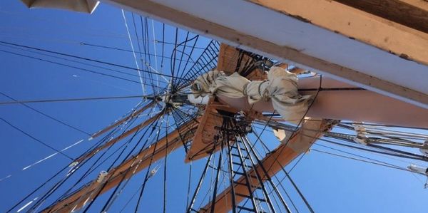the mast, sails, and ropes of a ship