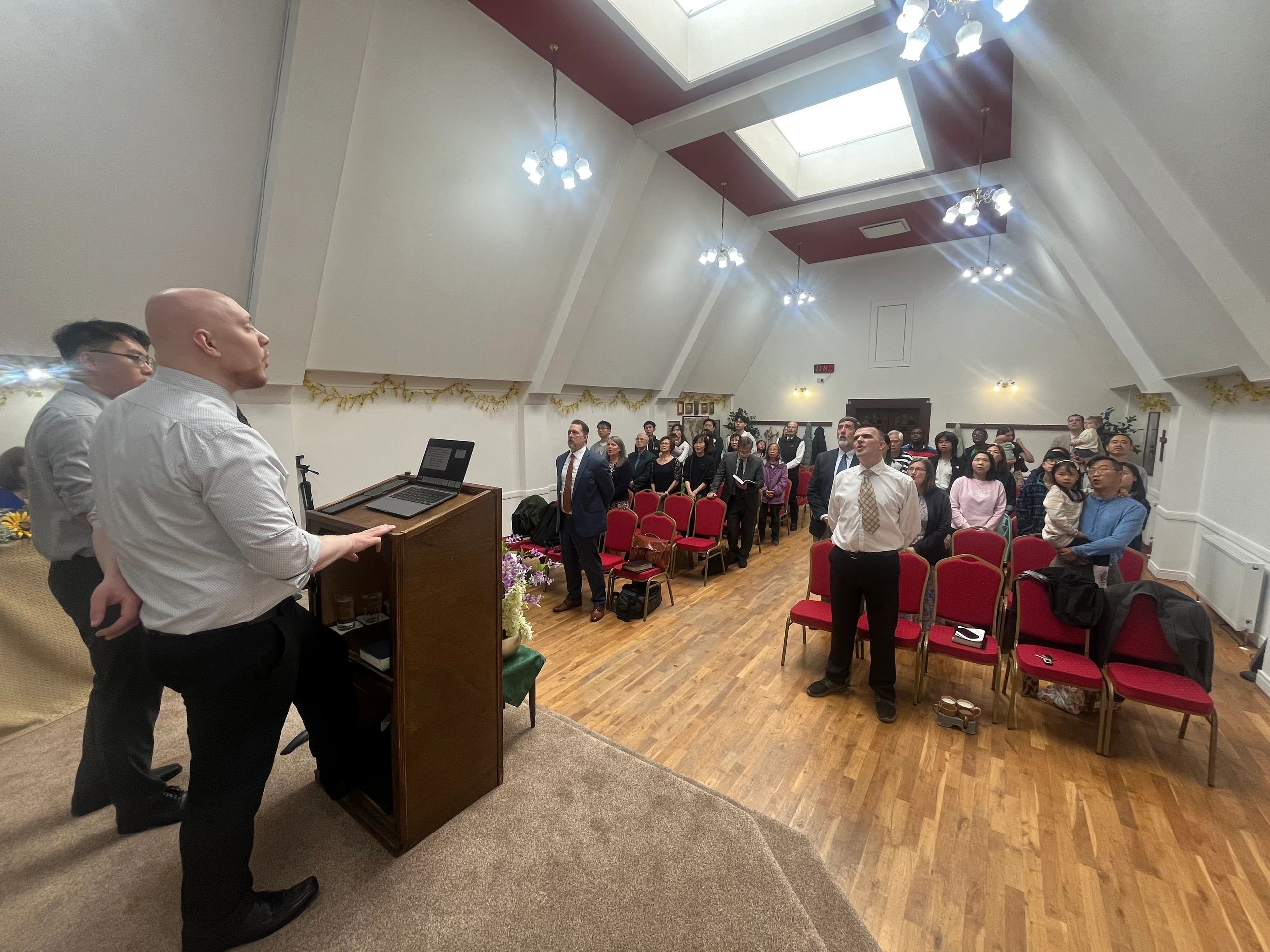 People gathered in a room for a meeting or service.