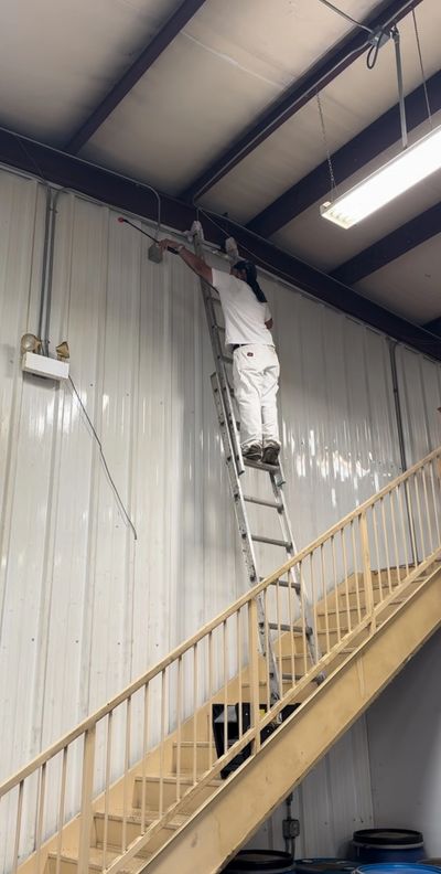 Anaya pro painting crew member cleaning commercial building prepping before repainting 