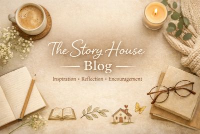 Cozy workspace with coffee, books, and a candle for The Story House Blog.