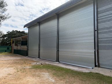 Large closed metal roller doors on a building.