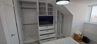Shaker style built-in wardrobe with recessed  TV, hanging rails and shelving