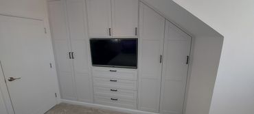 Shaker style built-in wardrobe with recessed  TV
